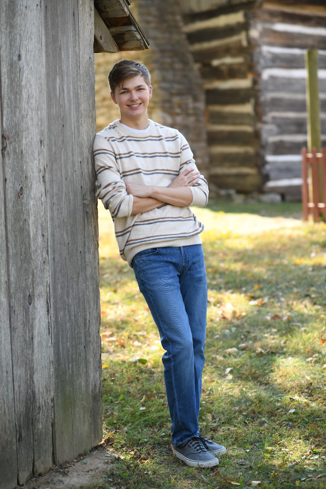 Parker Blaine leaning against a weathered barn wall